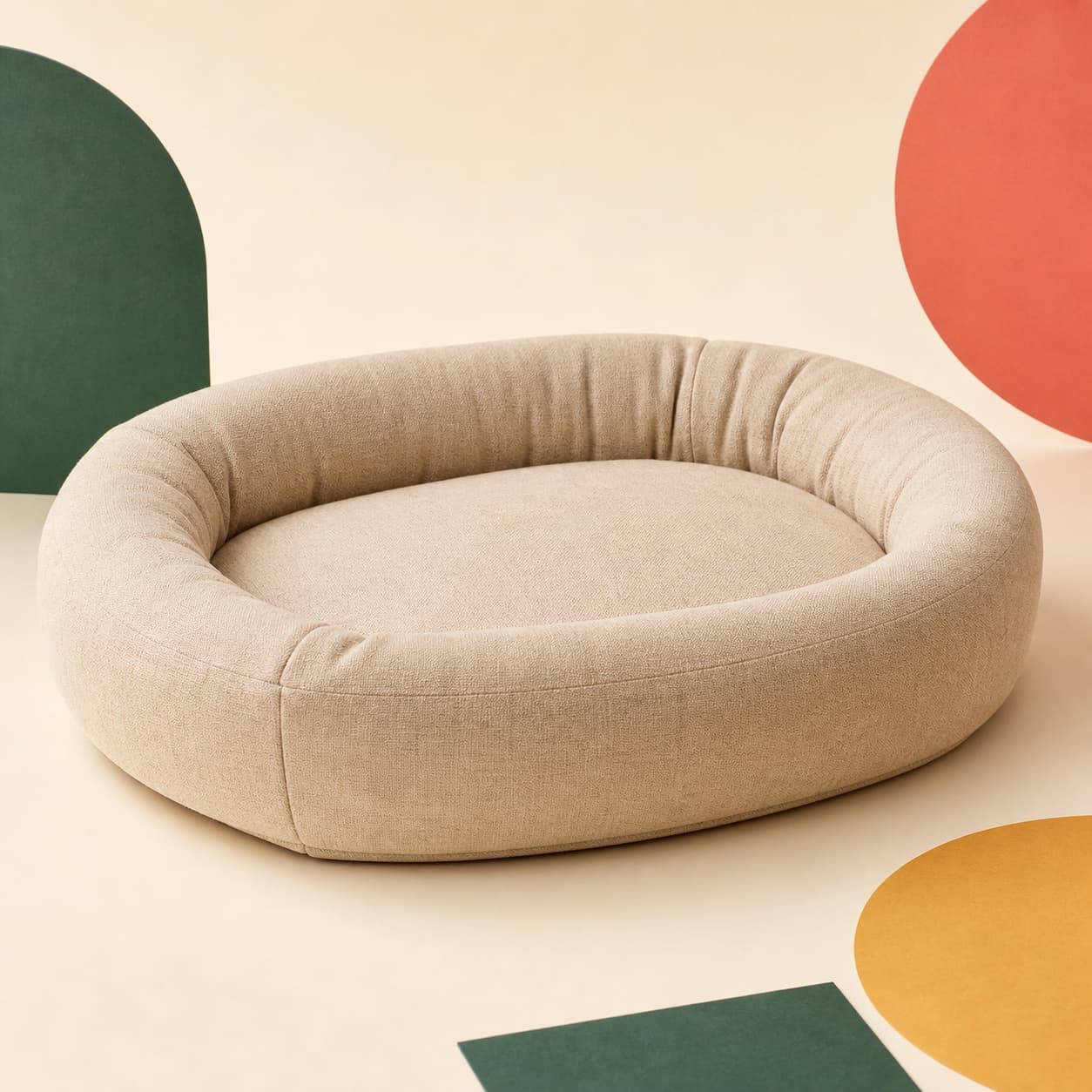 Oat-colored Cloud Nap pet bed on a warm cream studio backdrop.